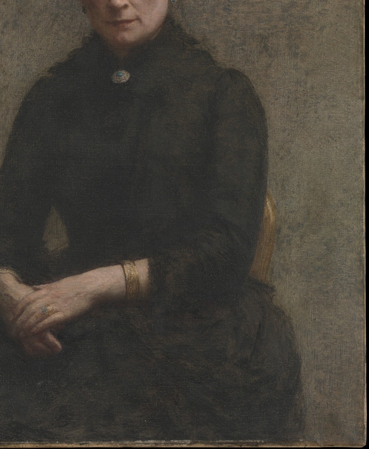 The rich, dark fabric with subtle folds creates a sense of depth and emphasizes the sitter's form.
