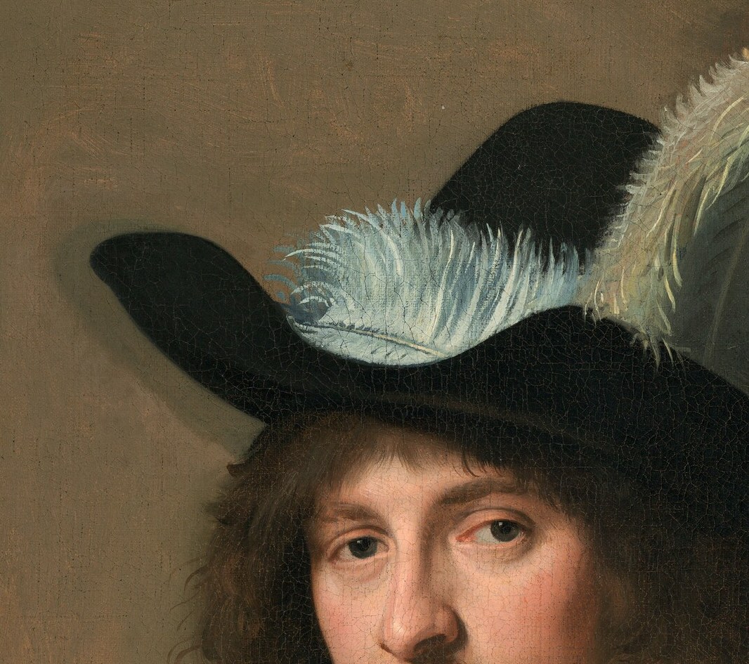 The elaborate hat with its soft feathers suggests status and a touch of vanity.