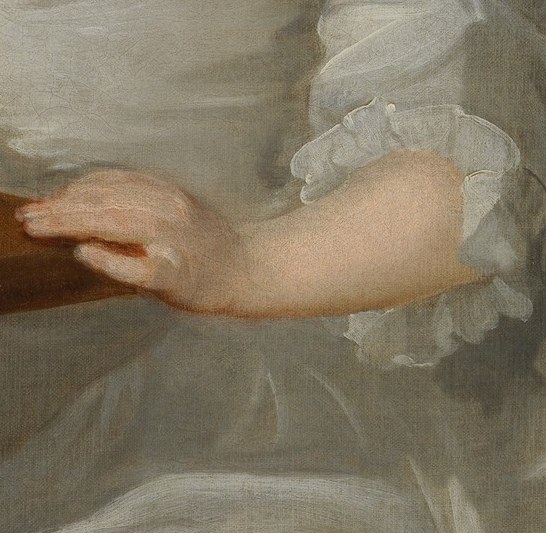 Her hands are poised, mid-task, holding a delicate balance.