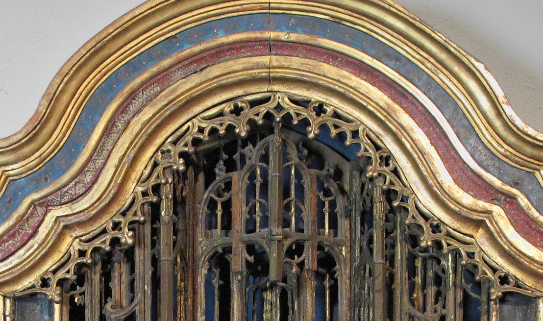 Deeply carved architectural micro-canopy frames the scene like a church within a church , the spires recede into gold shadow and reward close inspection.