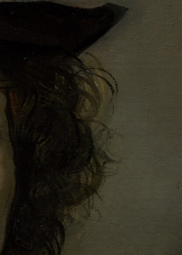 Now find the right ear, under the hat brim.