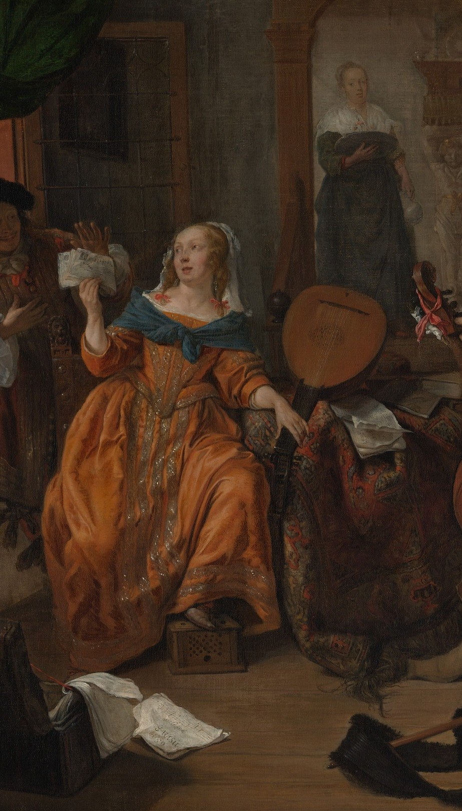 The compositional anchor; her orange-gold gown commands the eye and her posture and gesture drive the scene's narrative ambiguity.