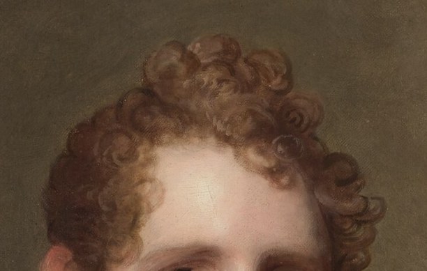 The tousled, reddish curls add a touch of youthful energy and perhaps a hint of artistic flair to his demeanor.