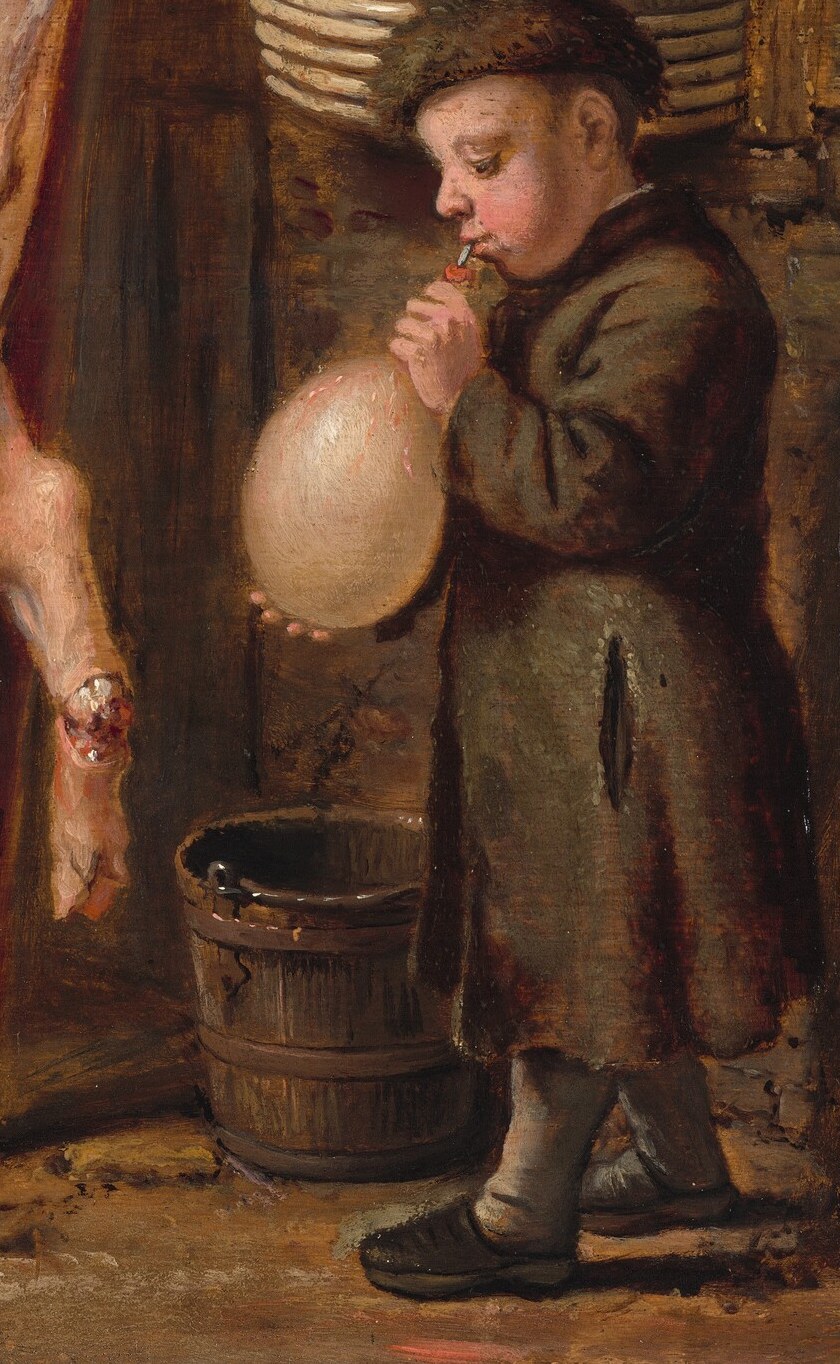 Another boy blows into an animal bladder.