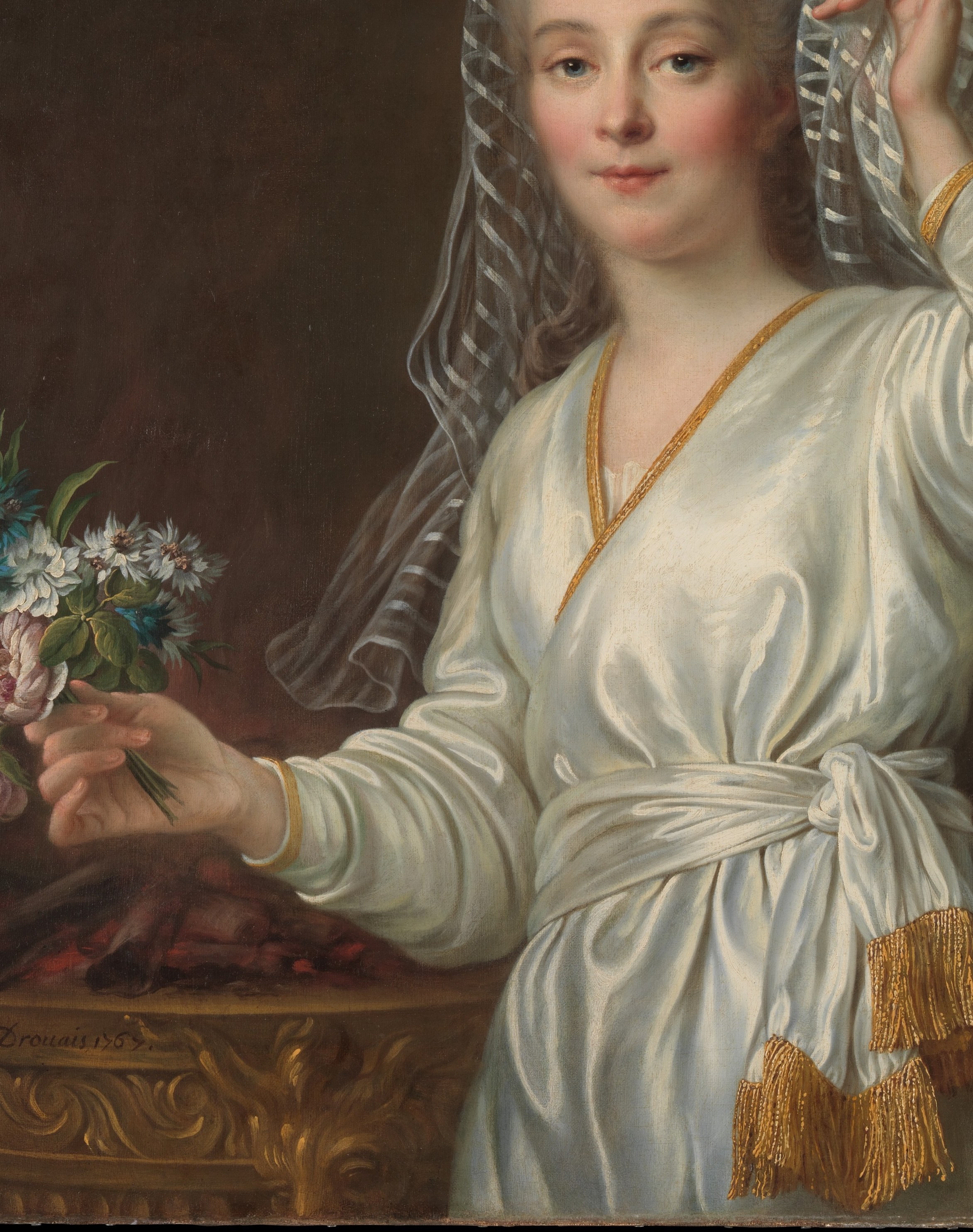 The gown's brilliant white against the dark background is a deliberate lighting strategy; Drouais uses it to make the sitter emerge from shadow like a candle flame.
