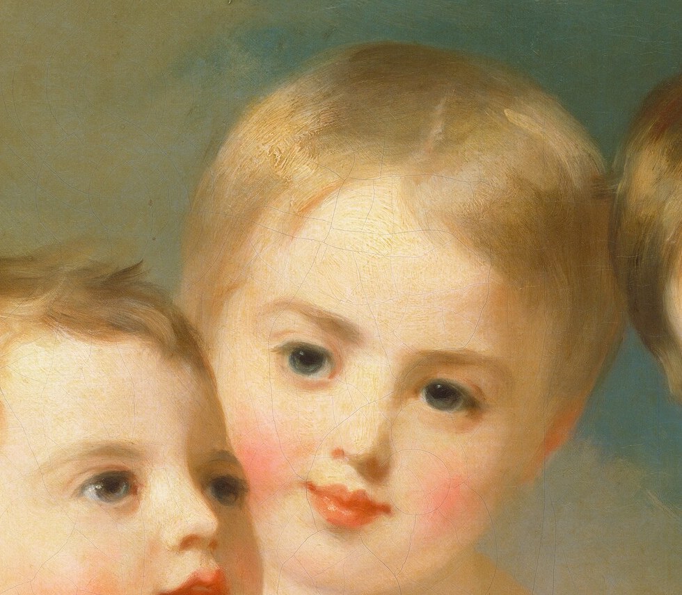 Features rosy cheeks and a direct gaze, conveying a sense of engagement and warmth.