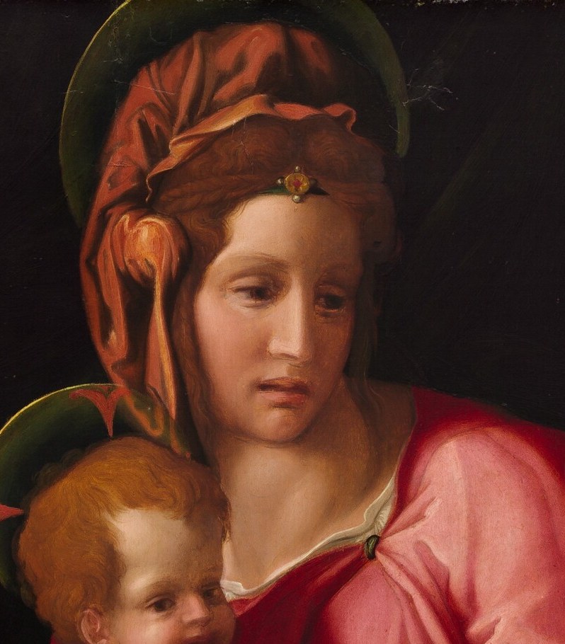 Her slight downward glance and composed expression convey quiet maternal tenderness , the emotional axis of the whole composition.