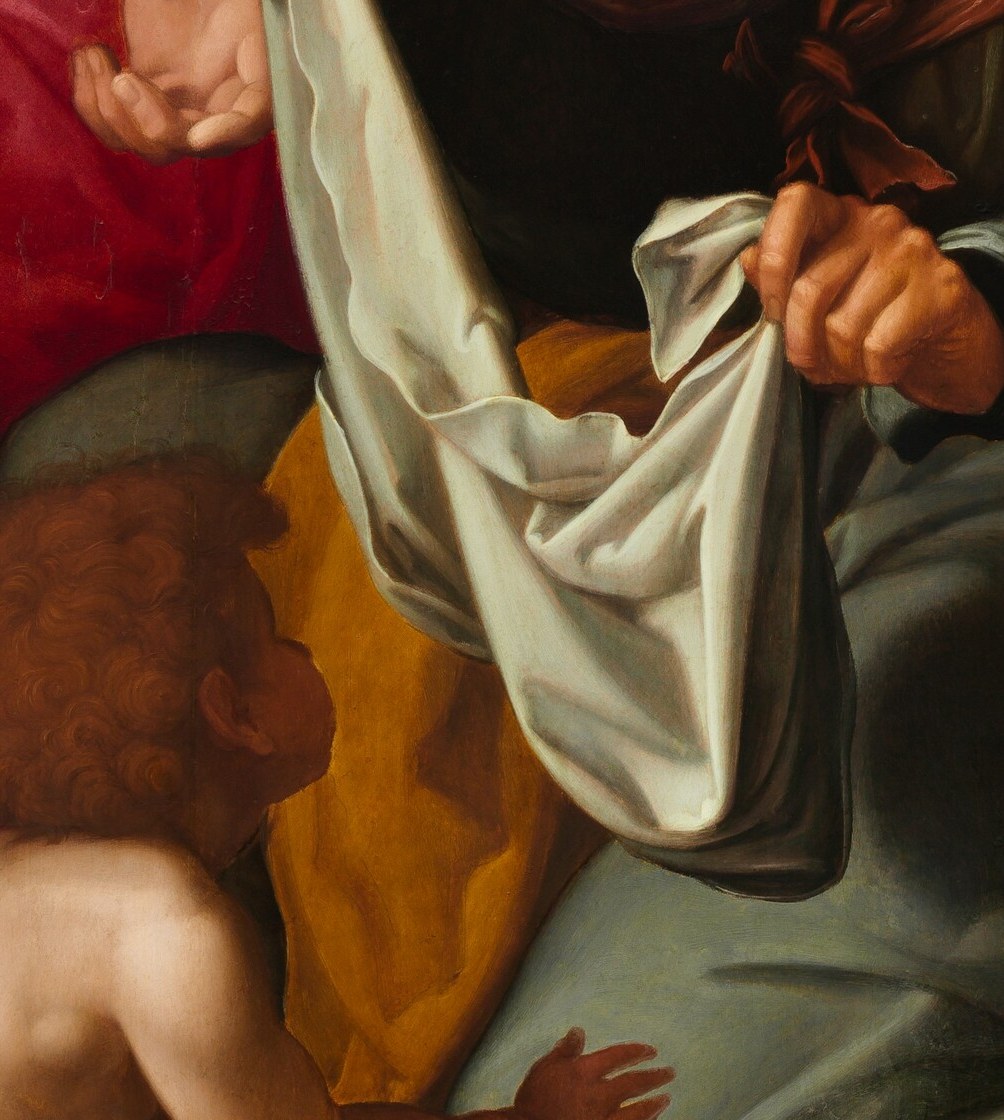 The painter gives us a clue in the center: a white cloth.