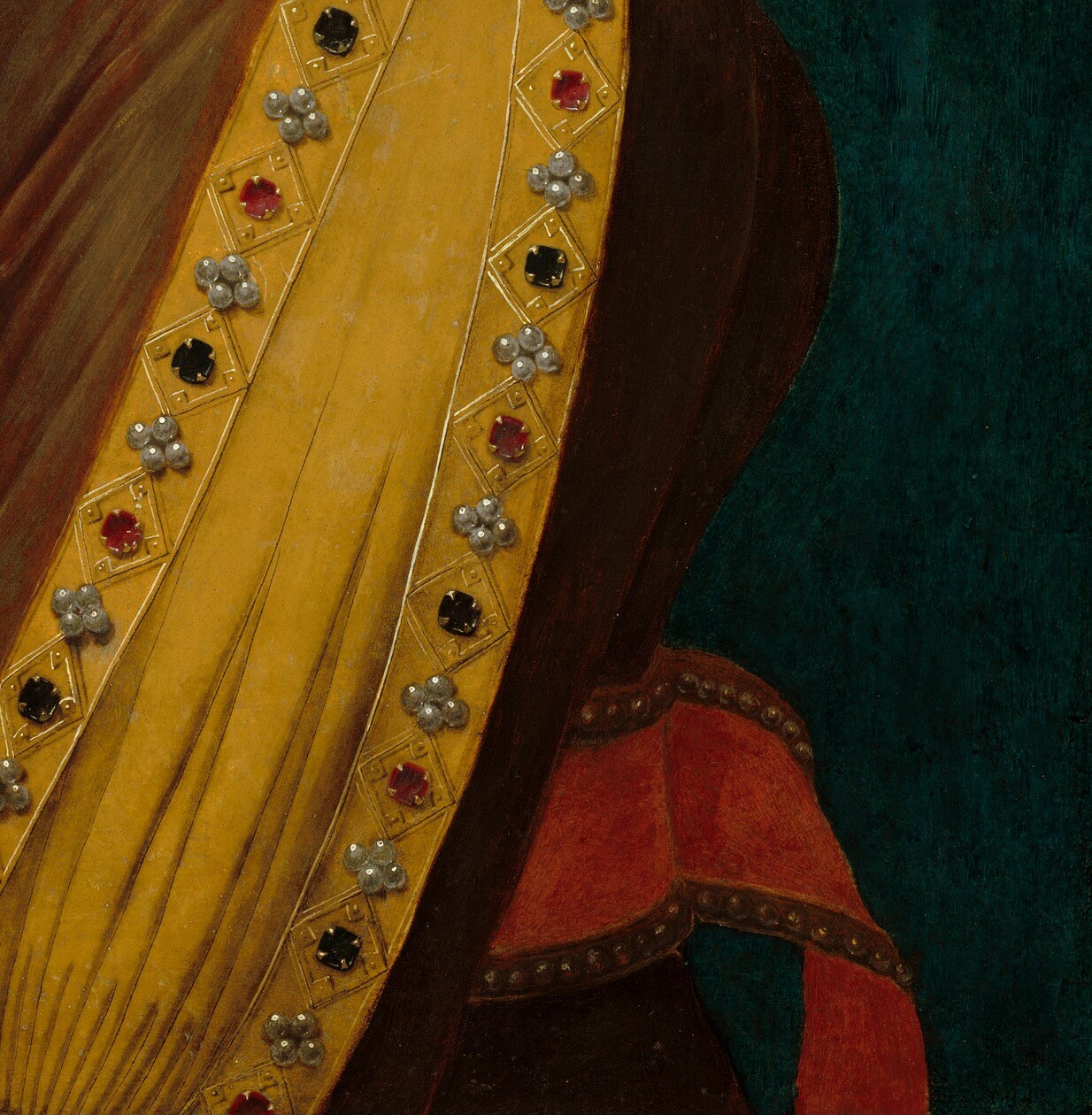 The deep color and rich texture of the gown provide a strong contrast to her lighter garments and skin.