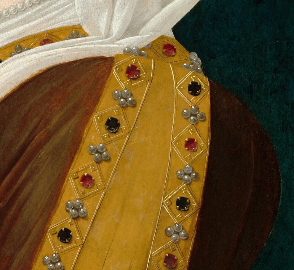 Her jeweled yellow vest and rich gown were cutting-edge fashion.