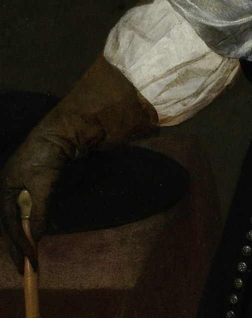 His gloved hand rests on a cane, conveying authority.