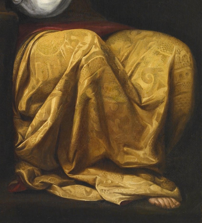 Even the rich brocade feels real, an echo of her past.