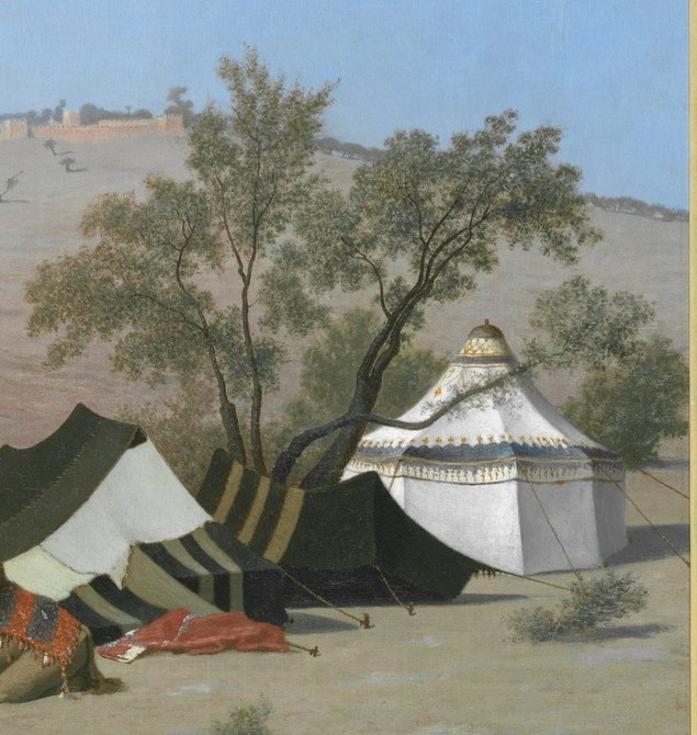 A white tent stands in contrast to the stone city.