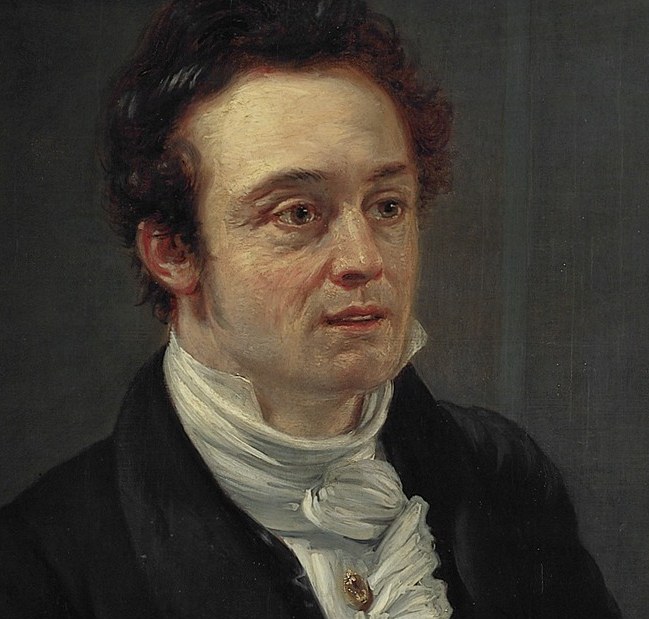 His gaze is directed outward, suggesting contemplation or engagement with the viewer, conveying a sense of presence.