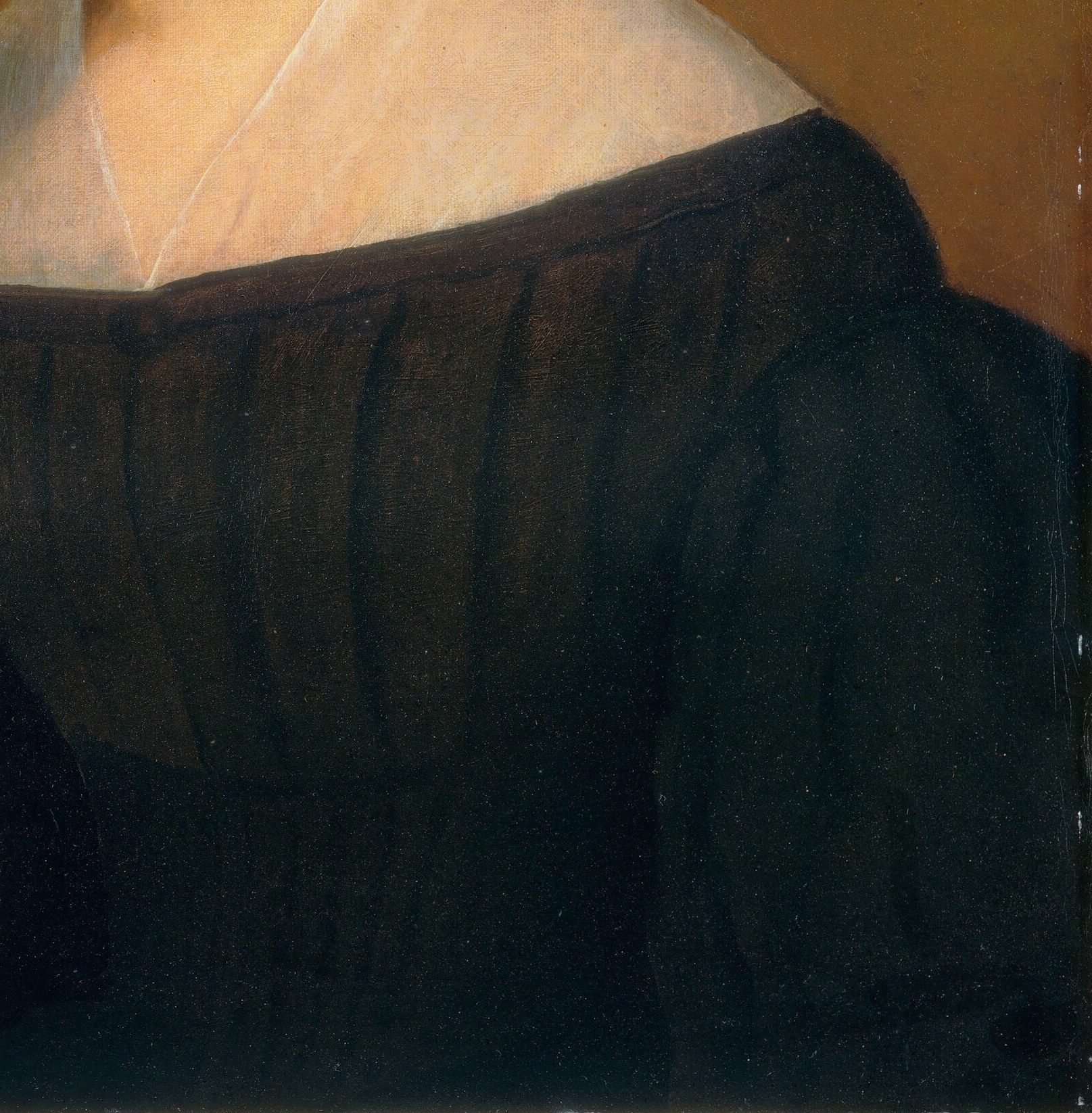 The rich fabric and dark color suggest status and modesty.