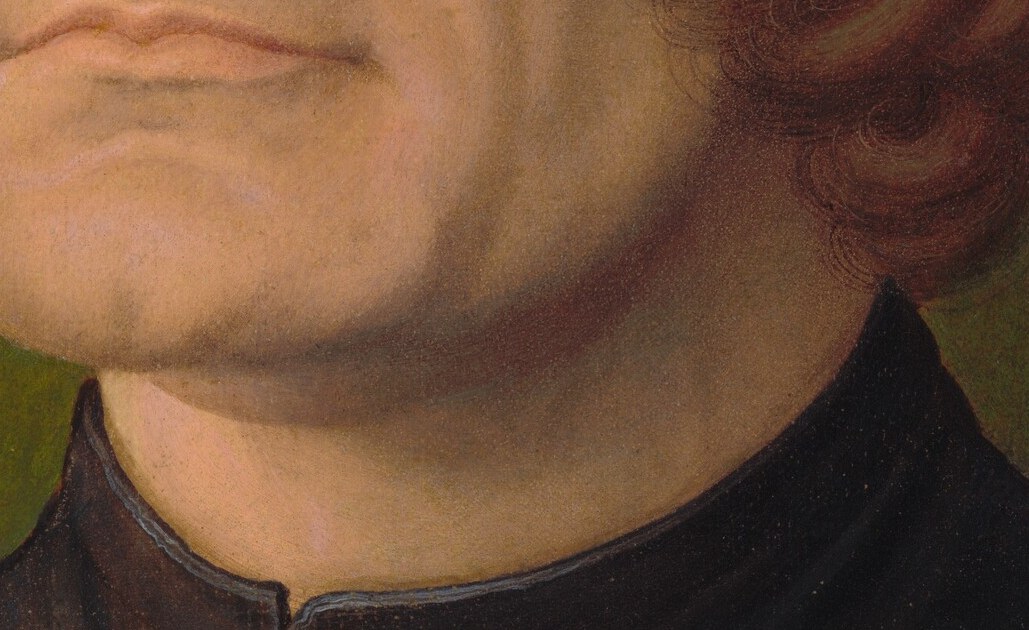 His mouth is set with a resolve that costs him.