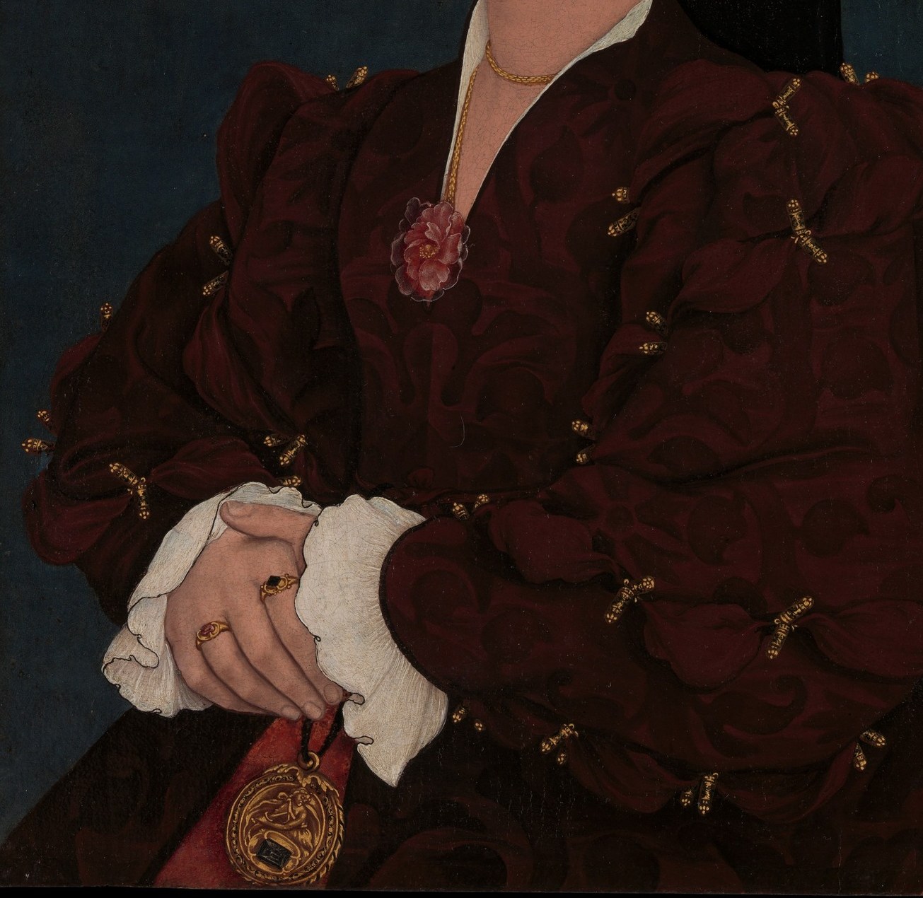 Crimson velvet was among the most expensive fabrics of the period; the light-absorbing red creates a grave, weighty presence while the subtle surface highlights demonstrate the painter's command of tonal modulation in dark hues