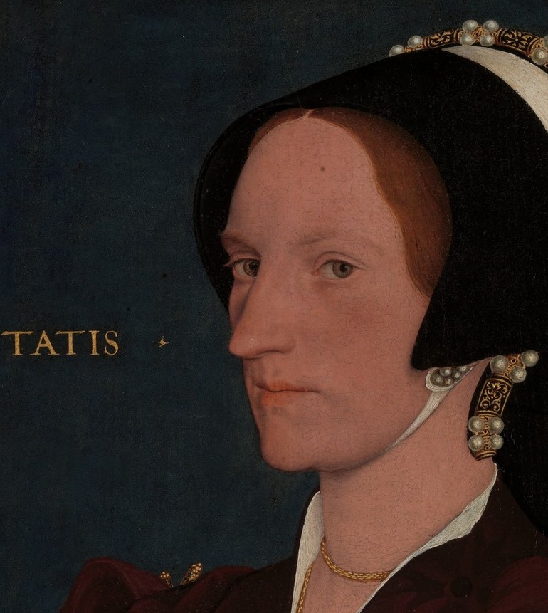 The primary expressive center , composed and watchful, the three-quarter pose was the prestige position in Holbein-era court portraiture; her gaze suggests self-possession rather than submission to the painter