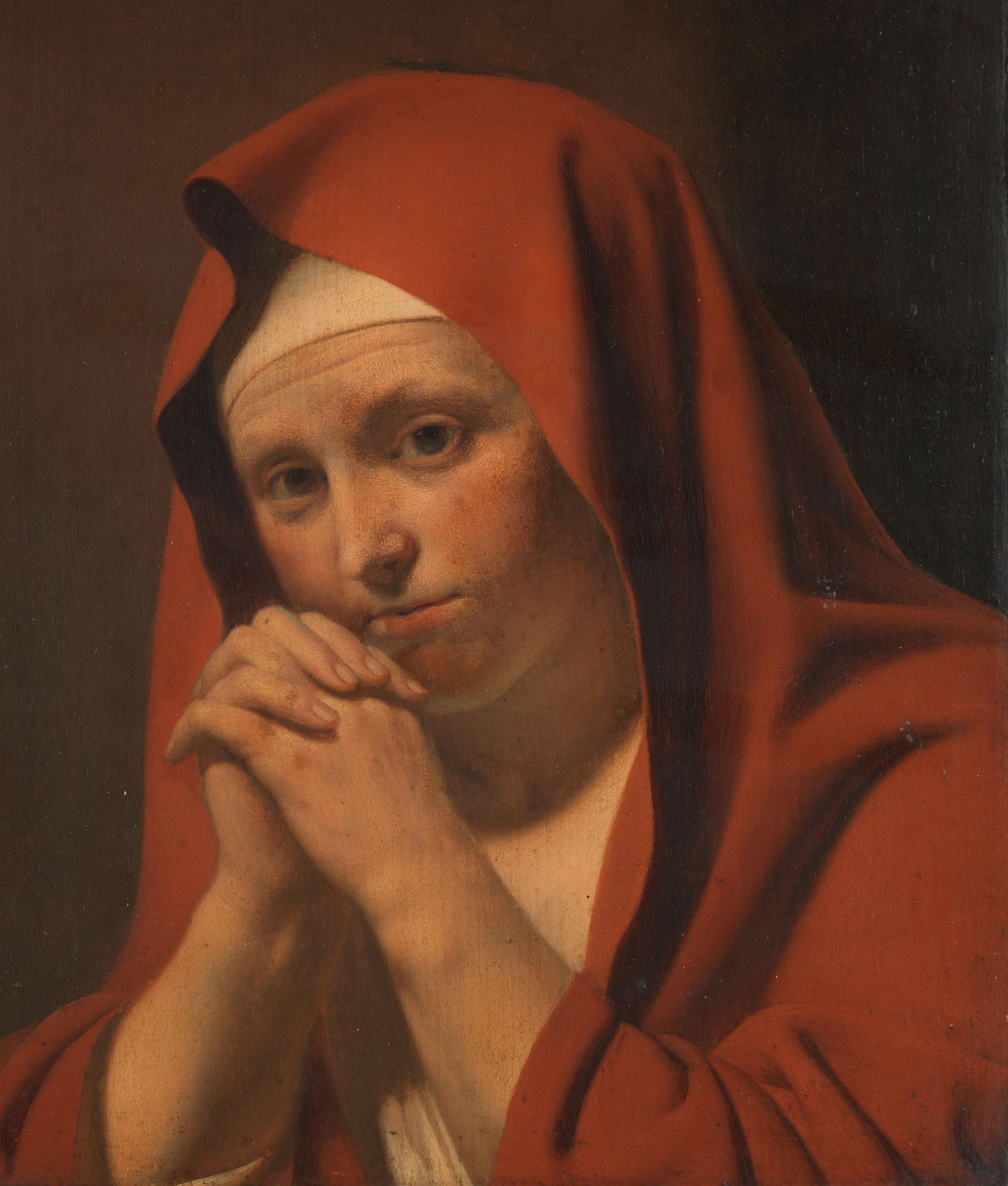 The heavy red fabric catches light in dramatic folds.