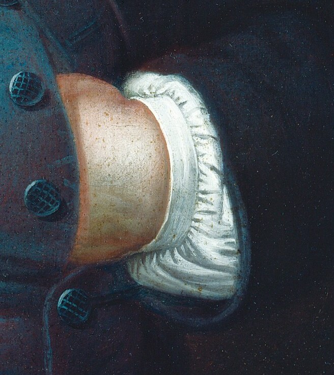 His right hand rests with a sense of ease and self-assurance.