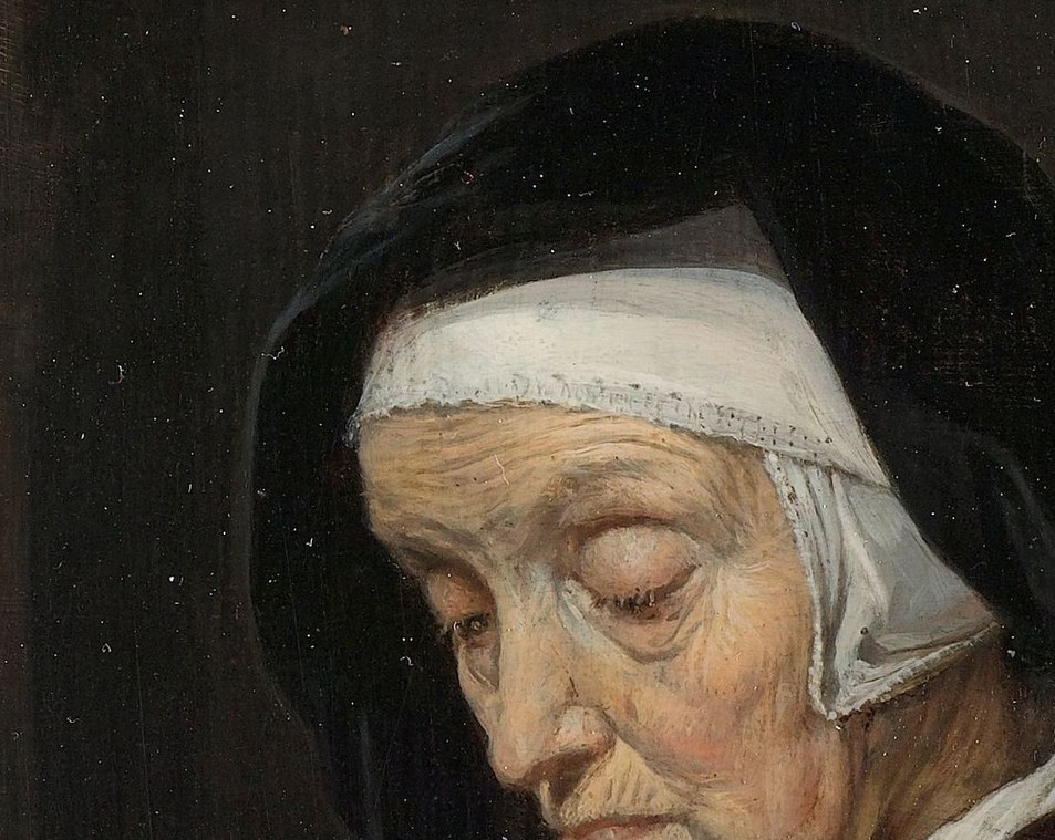 She wears a simple, crisp white head covering.