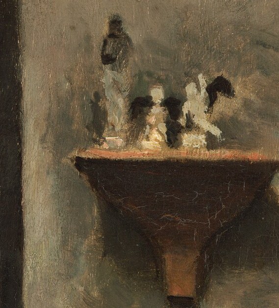 Look at the small sculptures on the shelf.