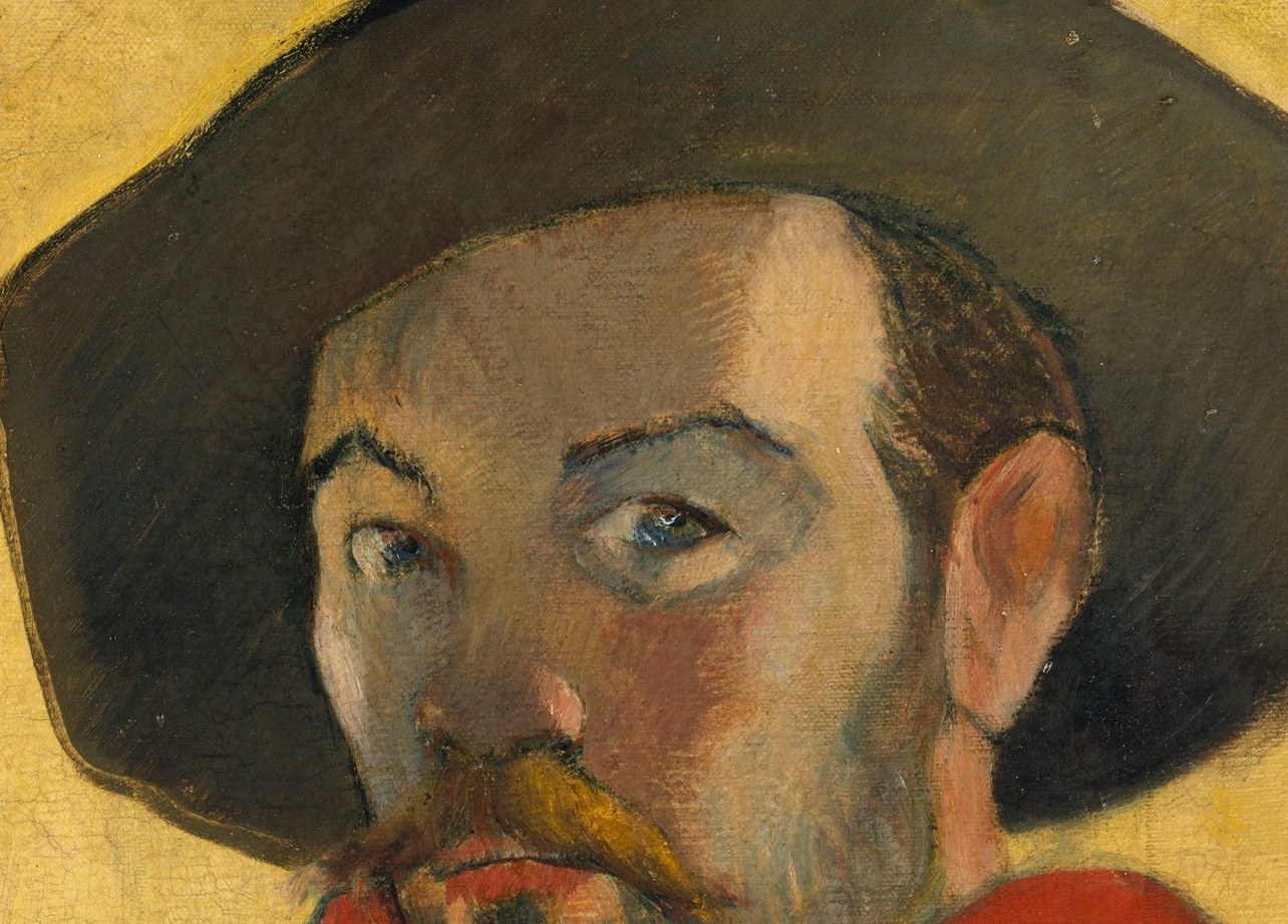 The hat casts a shadow, adding to the dramatic chiaroscuro and framing the face.