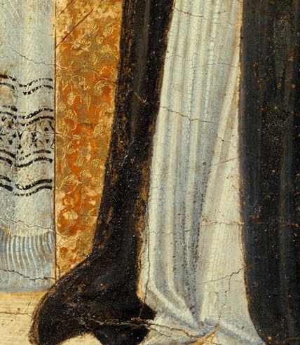 She receives the Host directly from a divine figure.