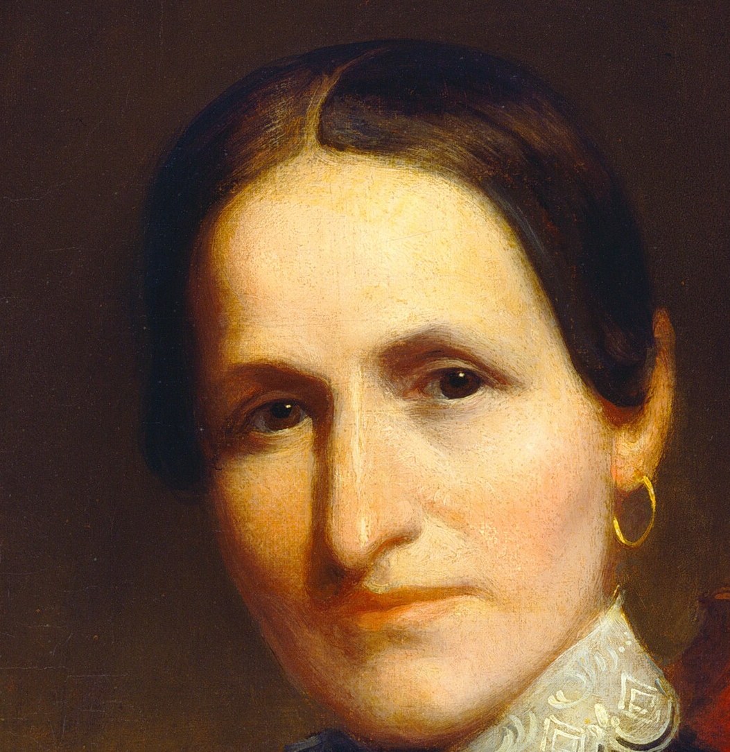 She wears a solemn expression, typical of portraits then.