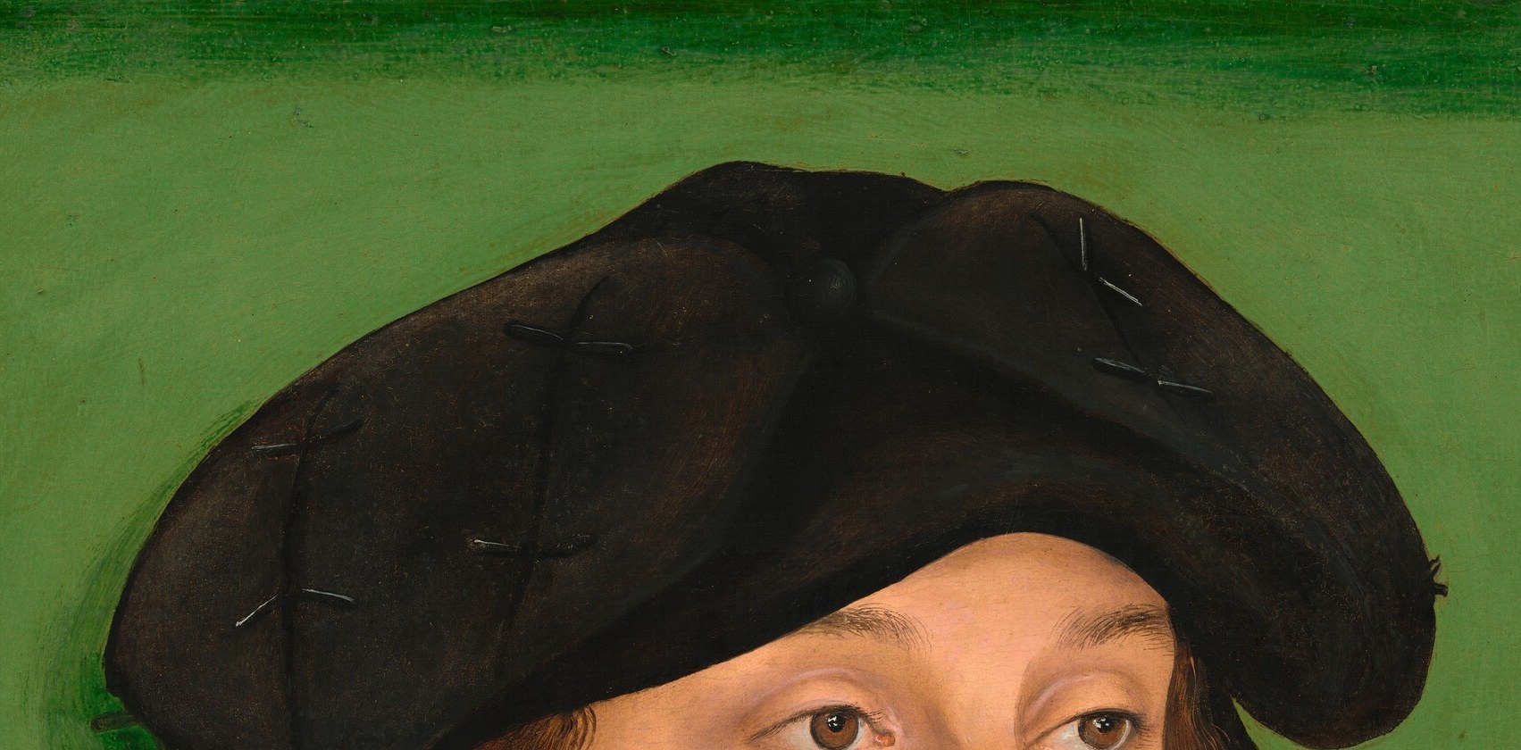 A fashionable flat cap of the 1520s German merchant or humanist class; its plain black silhouette anchors the upper composition and encodes status without ostentation.