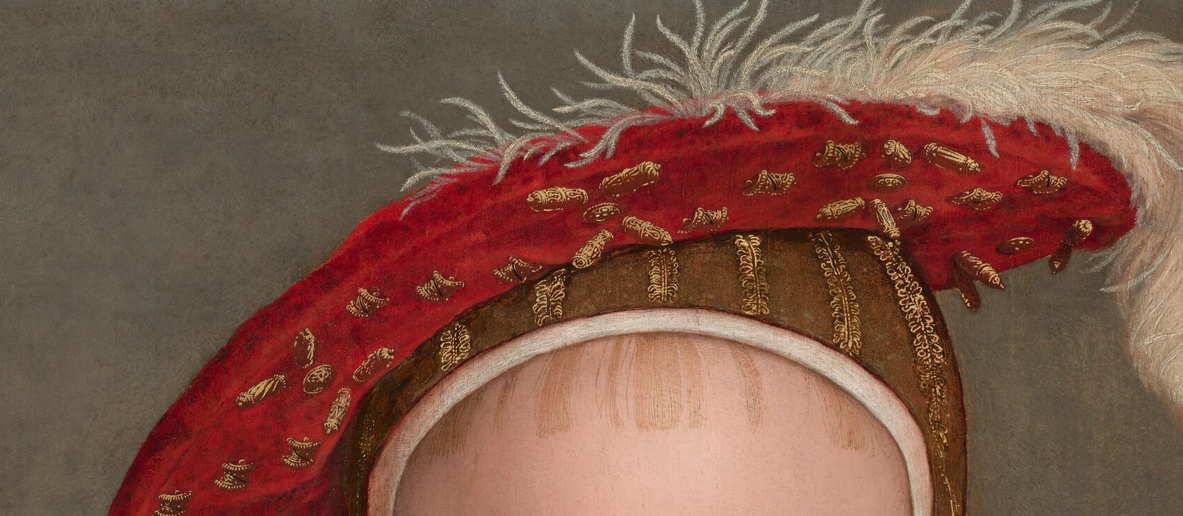 The scarlet cap and white plume are the heraldry of the Prince of Wales.