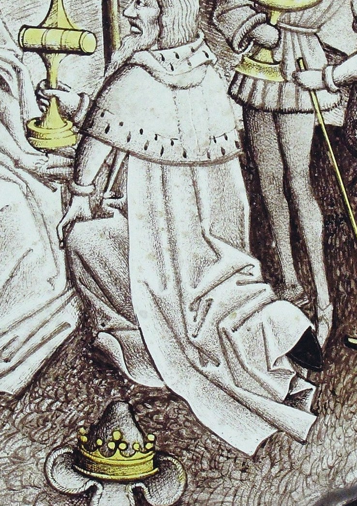 The first Magus kneels, offering a golden cup.