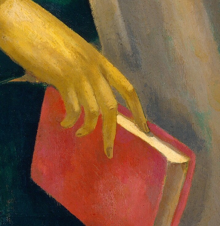 Her hands carefully hold it, suggesting reverence or study.