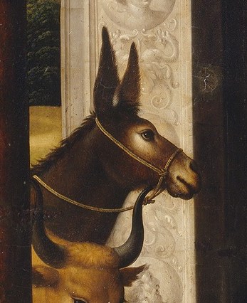Its gentle gaze and presence add a touch of humble realism to the sacred scene.