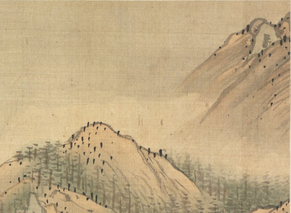 Mist shrouds distant peaks, creating a sense of scale.