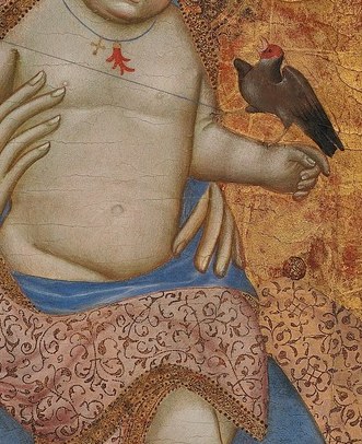 He holds a goldfinch in his hand.