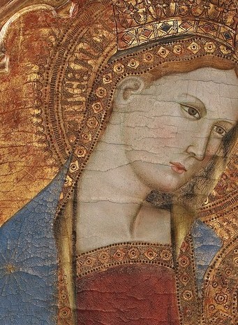 Her gaze is directed downwards, suggesting a gentle interaction with the child, conveying maternal tenderness.