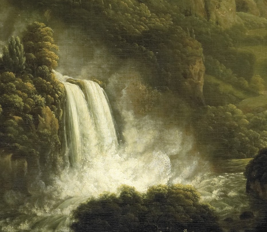 The bright white of the water contrasts with the dark rocks, highlighting its force and volume.
