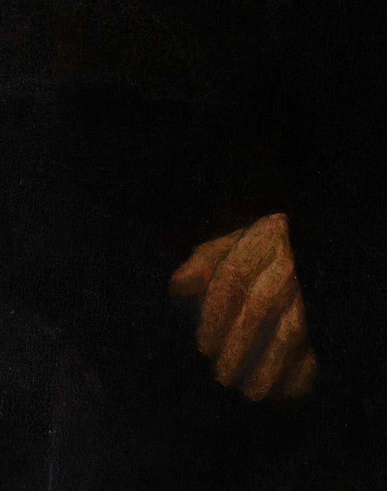 Hands at ease, but the firm mouth never smiles.