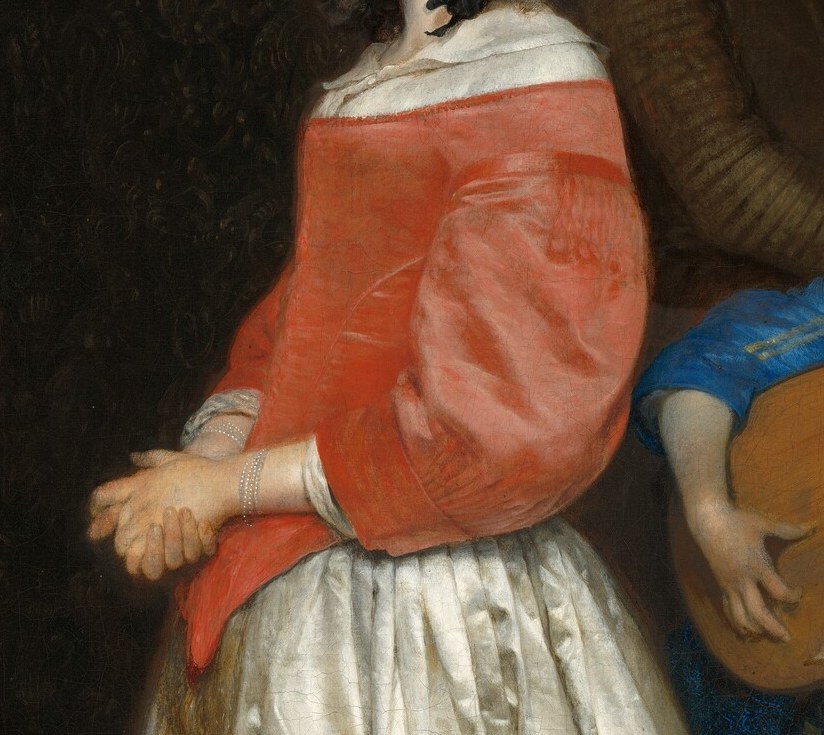 Her vibrant red bodice draws the eye to her demure pose.