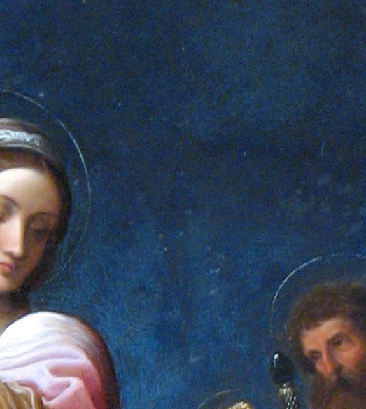 The book , likely scripture , is displayed prominently as if shown to the viewer; the Christ Child reaching for it makes it the theological pivot of the scene.