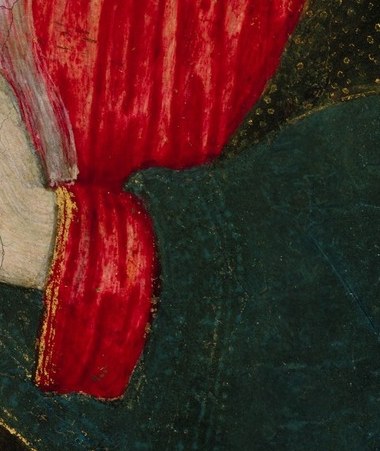 Her hands, folded in prayer, suggest deep contemplation.