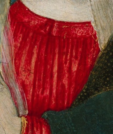 The vibrant red fabric draws the eye and symbolizes passion or divine love.