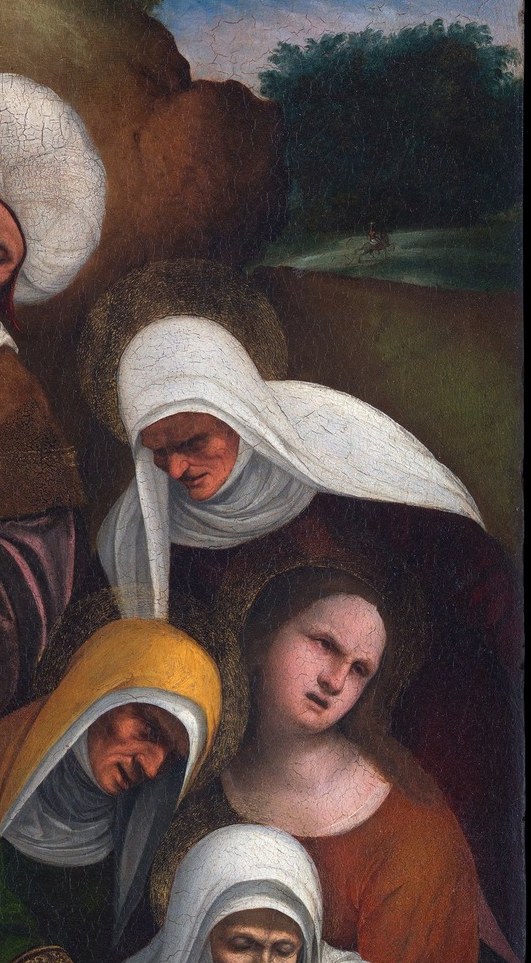 Her crumpled veil and downward gaze read as the most private grief in the painting; she anchors the right margin and balances the red-robed figure on the left.