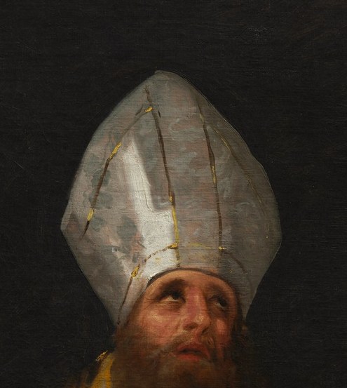 His mitre, the bishop's hat, signals his high ecclesiastical rank.