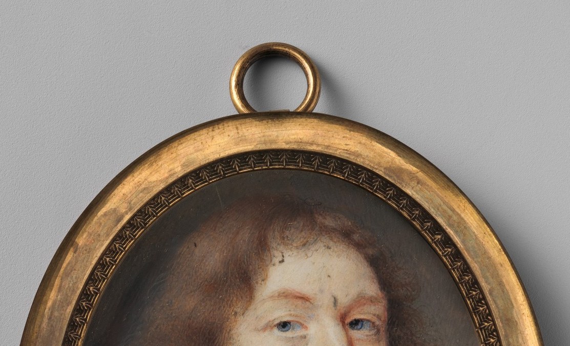 Yet his hair is cut in the long, loose style of a Cavalier.