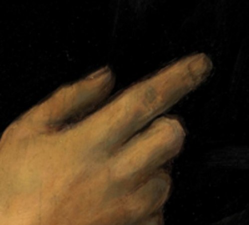 His subtly raised hand suggests he's about to speak.