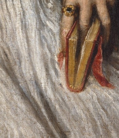He grasps a pair of gold-handled scissors.