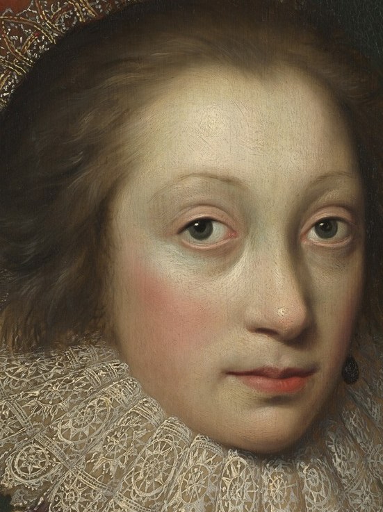 Her direct gaze and slightly parted lips create an intimate and engaging portrait, inviting the viewer to connect with her.