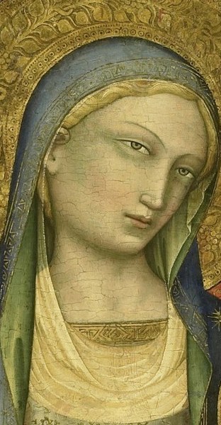 Her serene face expresses maternal love and spiritual calm.